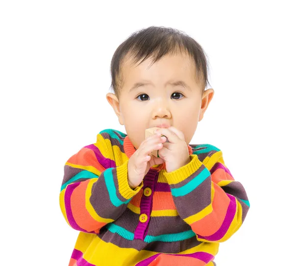 Bébé fille mis jouet bloc dans la bouche — Photo