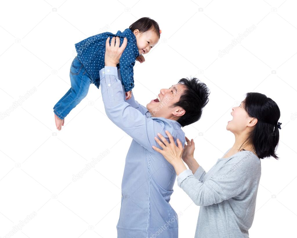 Asia father throw his baby up with smile wife