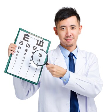 Male doctor holding optometry chart and magnifying glass clipart