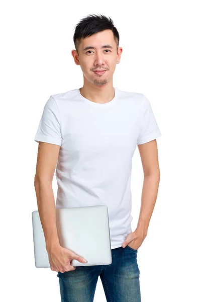 Smiling young man holding computer — Stock Photo, Image