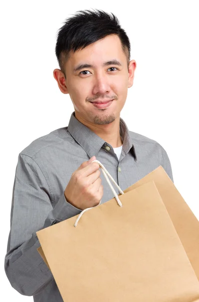 Bello uomo con shopping bag — Foto Stock