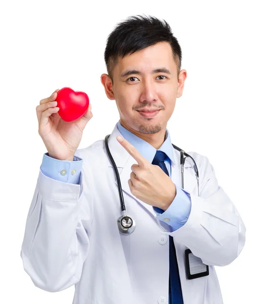 Medical doctor holding heart squeezing ball — Stock Photo, Image