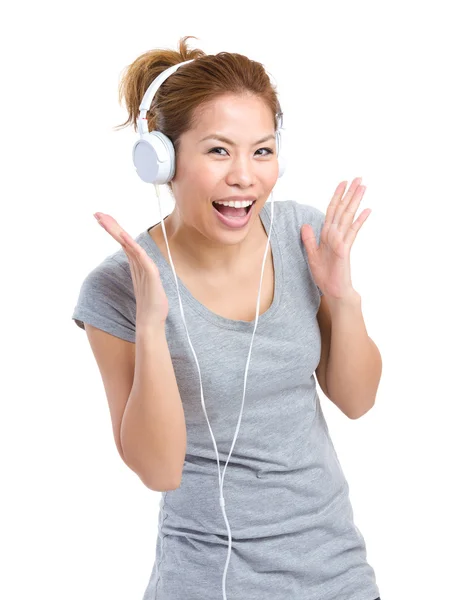 Excited woman listening to headphone — Stock Photo, Image