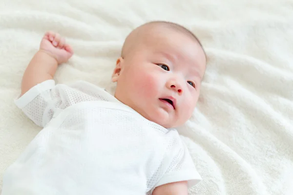 Newborn baby lying in bed — Stock Photo, Image