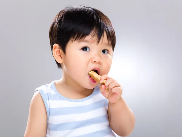 Baby eating biscuit — Stock Photo, Image