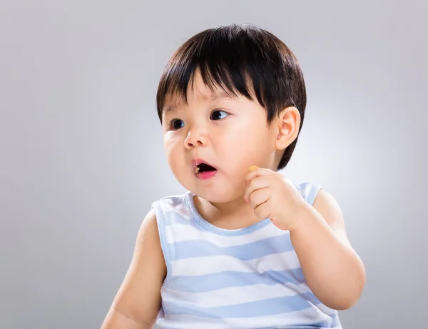 Funny little baby eating biscuit — Stock Photo, Image