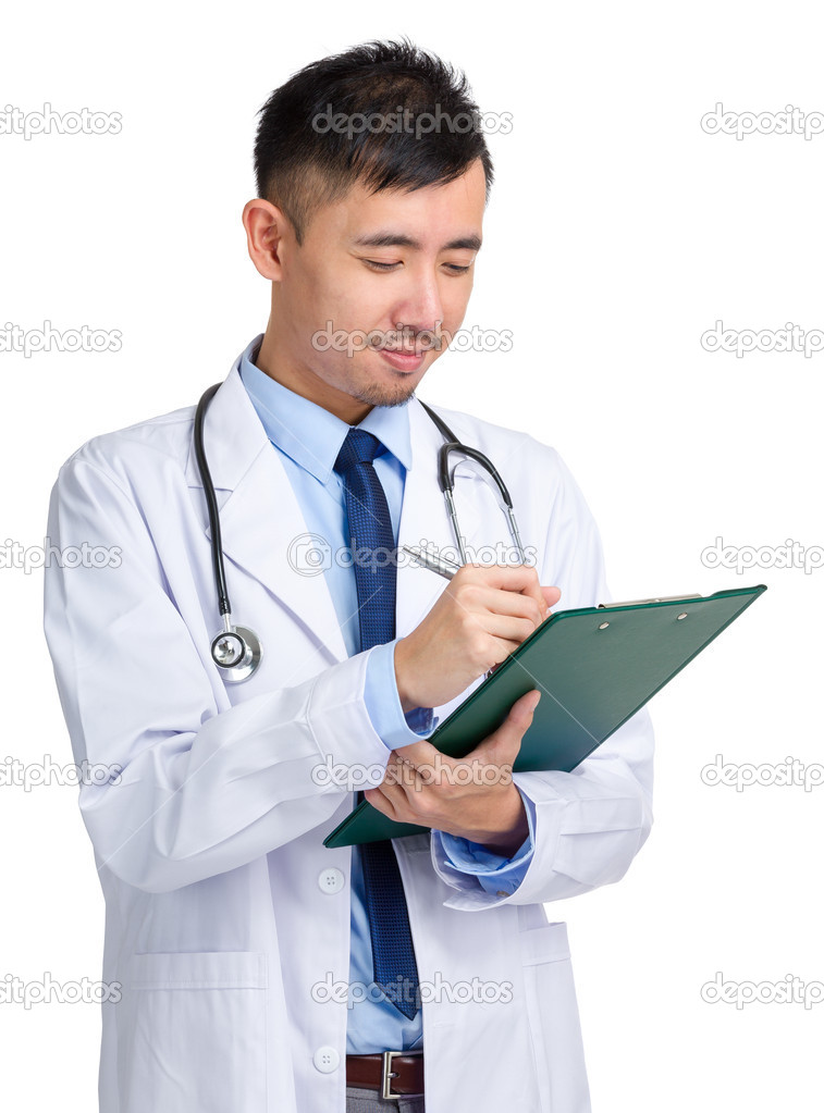Male doctor writing on folder