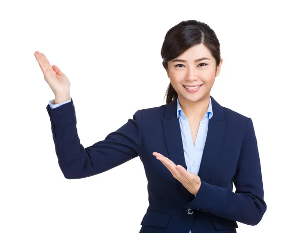 Young businesswoman presenting by hand — Stock Photo, Image
