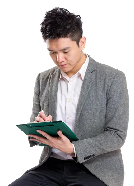 Business man write on clipboard Stock Picture
