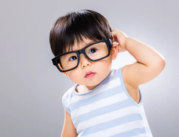 Bebé niño usar gafas y rascar el pelo — Foto de Stock