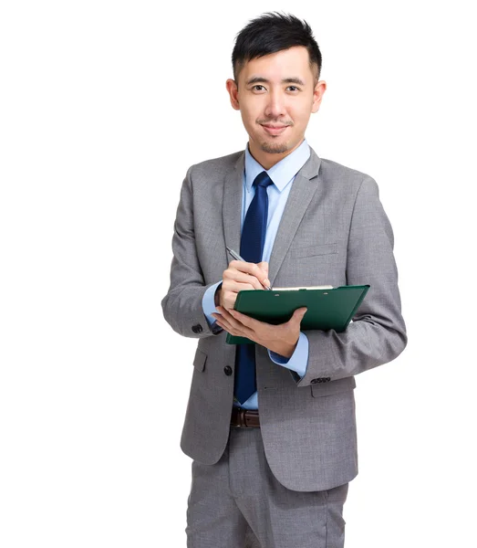 Businessman writr on clipboard — Stock Photo, Image