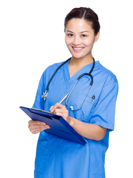 Asian doctor take note on clipboard — Stock Photo, Image