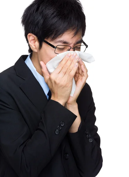 Asian businessman sneezing — Stock Photo, Image