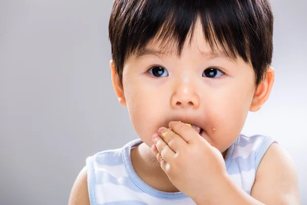 Asian baby boy eat cookie close up — Stock Photo, Image