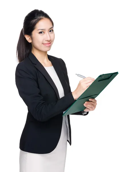 Asian businesswoman write on clipboard — Stock Photo, Image