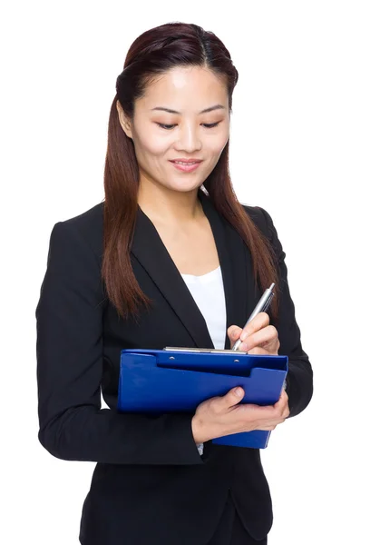 Business woman write something on file pad — Stock Photo, Image
