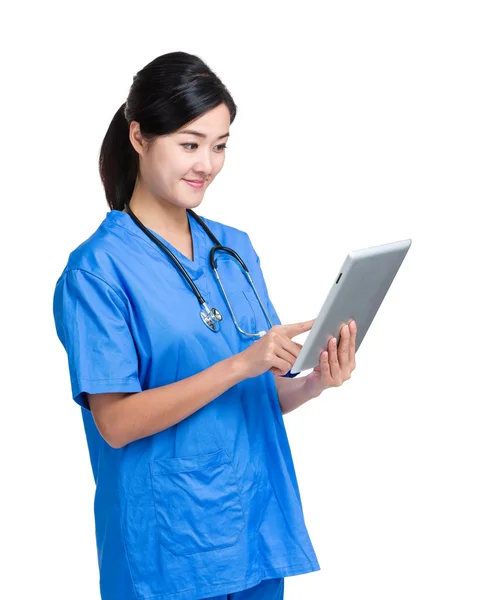 Mujer médica asiática mira tableta digital — Foto de Stock