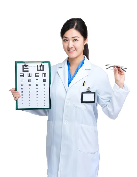 Woman doctor with eye chart and glasses — Stock Photo, Image