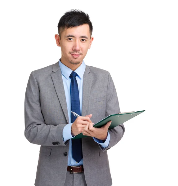 Asian business man write on clipboard — Stock Photo, Image