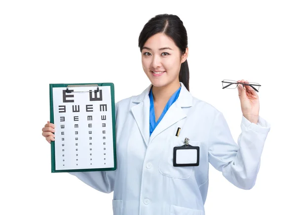 Female optician doctor hold glasses and showing eye chart — Stock Photo, Image