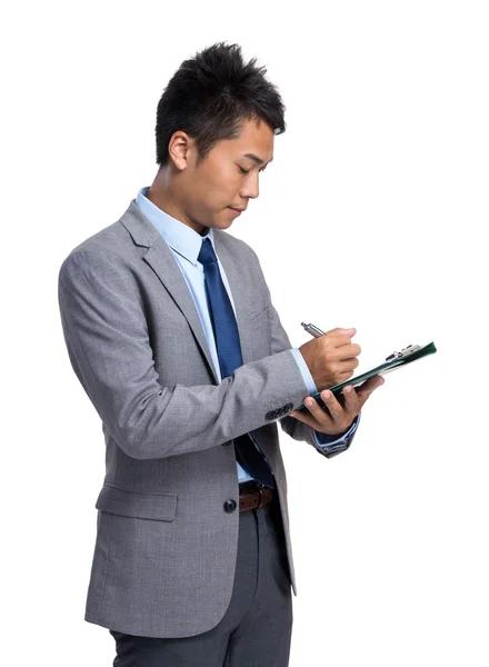 Asiático hombre de negocios escribir en portapapeles —  Fotos de Stock
