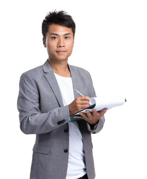 Asian businessman write on clipboard — Stock Photo, Image