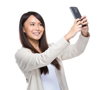 Asia young woman taking selfie with mobile phone isolated clipart