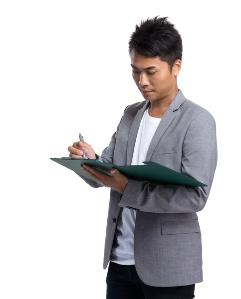 Businessman write on clipboard Stock Image