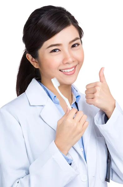 Dentist with toothbrush and thumb up — Stock Photo, Image