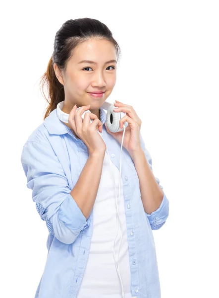 Woman hold headphone on shoulder — Stock Photo, Image