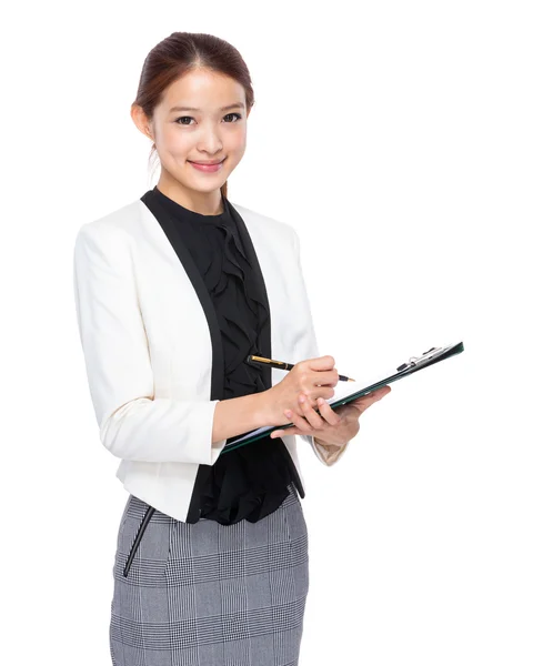 Asian young businesswoman take note on clipboard — Stock Photo, Image