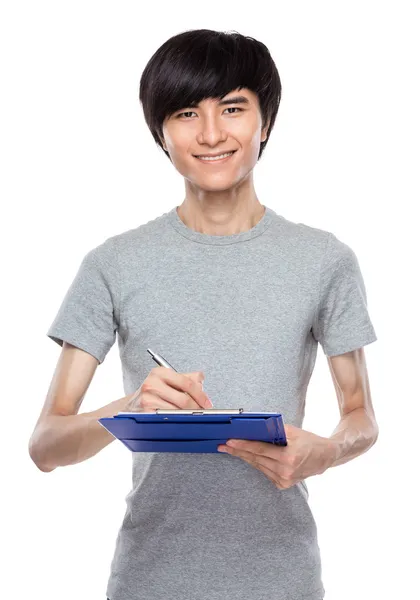 Young man take note on clipboard — Stock Photo, Image