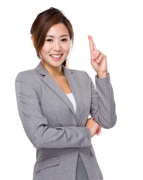 Happy businesswoman with finger crossed — Stock Photo, Image