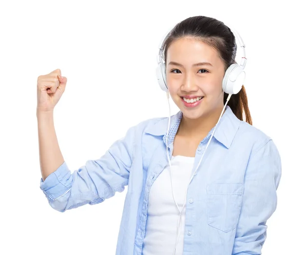 Asian young woman listen to music with headphone and arm clench — Stock Photo, Image