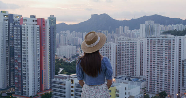 Woman go hiking and enjoy the city view of Hong Kong