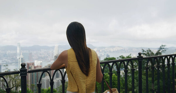 Woman look the the city in Hong Kong from the peak