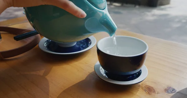 Pour hot water into cup