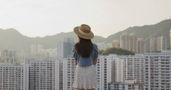 Woman enjoy the city view in sunset time