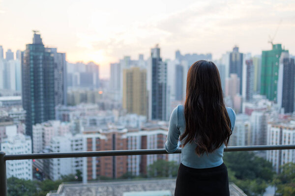 Woman look at the city of Hong Kong