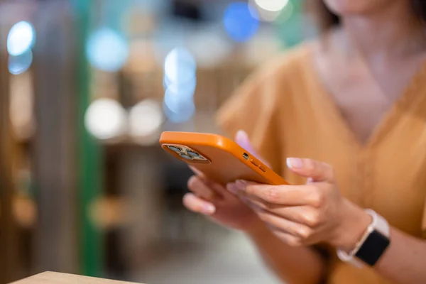 Woman use mobile phone at restaurant