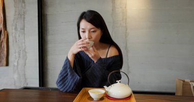 Woman enjoy hot tea in restaurant