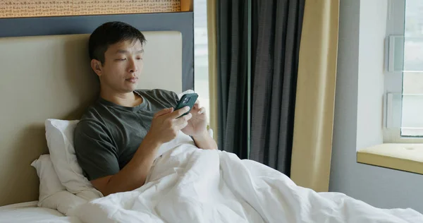 Asian Man Use Mobile Phone Sit Bedroom —  Fotos de Stock