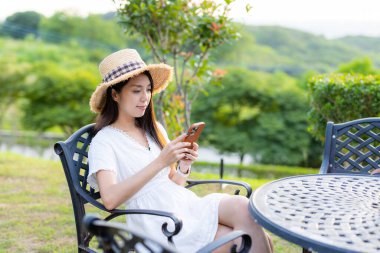 Travel woman use mobile phone at outdoor cafe