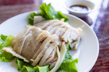 Slice of steamed chicken on plate