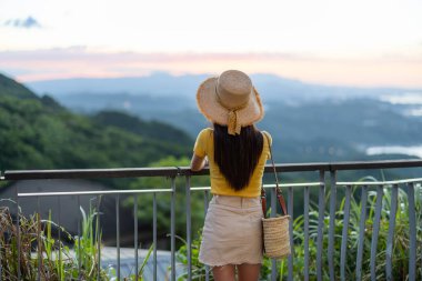 Woman look at the sunset in Jiufen of Taiwan
