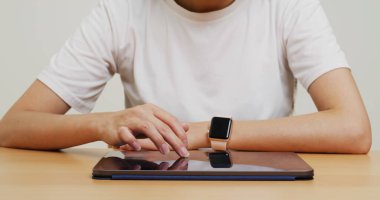 Woman touch on tablet computer on the table