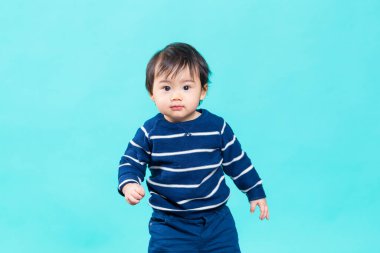Young baby boy on blue background
