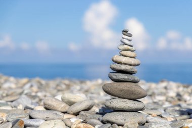Pebble tower balance harmony stones arrangement on sea beach coastline