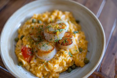 Scallop risotto dish in restaurant