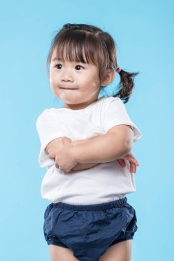 Little girl arm cross over blue background